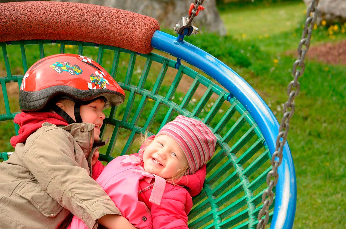 children laughing in swing